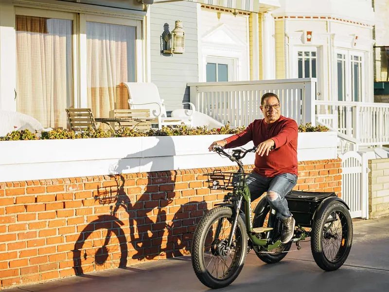 Pessoa pedalando um triciclo elétrico adulto